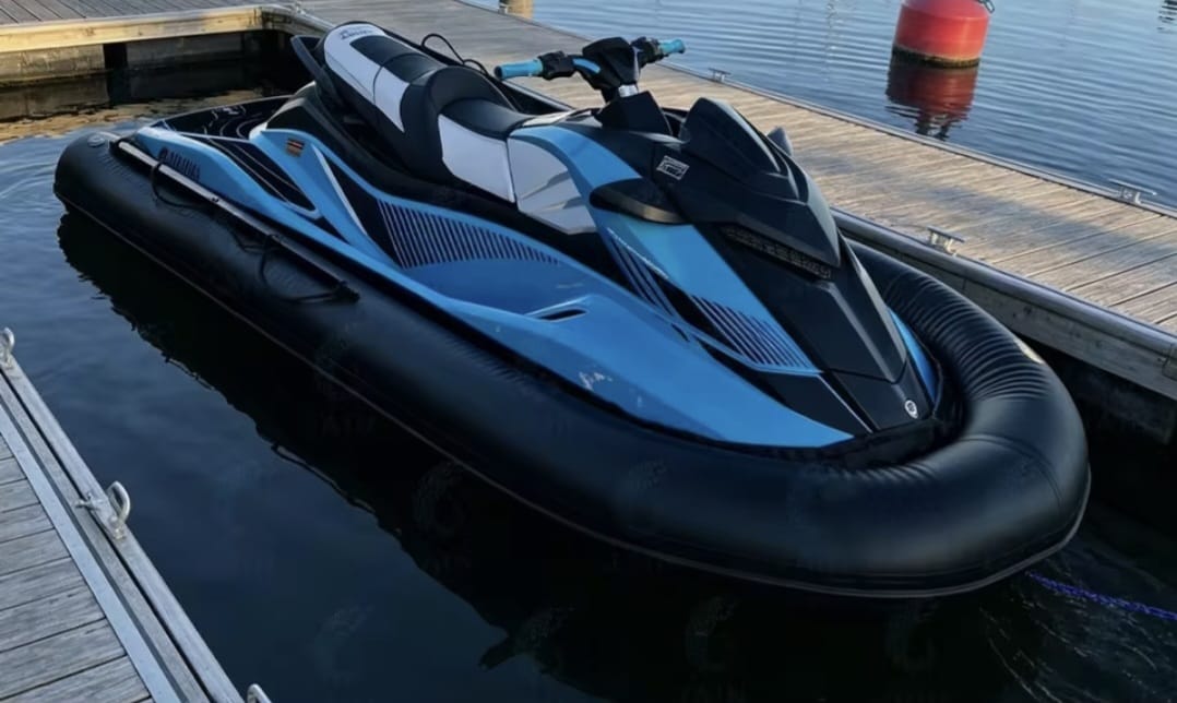 Jet ski fitted with a protective inflatable collar while docked at a marina